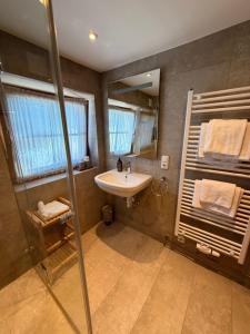 a bathroom with a sink and a shower at Hof Oberhaus in Kitzbühel +32 photos