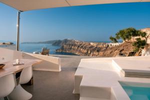 a white house with a view of the ocean at Nelya Suites in Megalochori