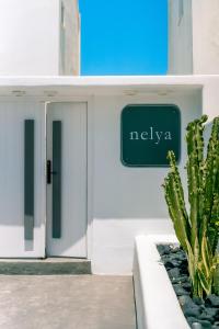 a sign on the side of a building with a cactus at Nelya Suites in Megalochori