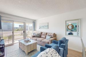 a living room with a couch and a table at ABPAB166 Sandy Shores in Atlantic Beach