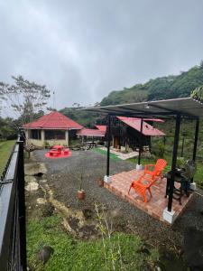 a patio with a bench and a grill and a house at Aire Agua y Naturaleza in Guácimo +14 photos