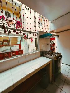 a kitchen with a counter and a stove in it at Ñusta Wasi in Cusco