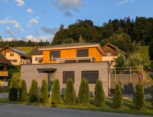 a house on a street with bushes and trees at TinyHouse - (D)ein Ferienhaus in Schellenberg