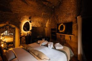 a bedroom with a bed in a stone room at Le Cocon in Doué-la-Fontaine