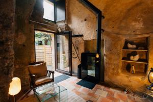 a room with a chair and a glass table at Le Cocon in Doué-la-Fontaine +15 photos