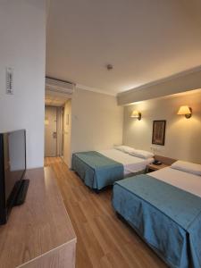 a hotel room with two beds and a flat screen tv at Haydarpasa Hotel in Istanbul +37 photos