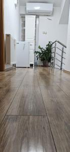 an empty room with a wooden floor in a building at Azul in Bihać