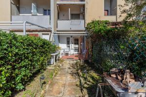 an outside view of a building with a yard at Cala Lupo Relax Veranda e BBQ nel verde in Stintino