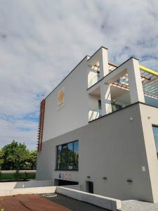 a white building with a sky in the background at Sunny apartment208 in Dunajská Streda