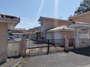 a black fence in front of a house at La coccinelle in Gujan-Mestras
