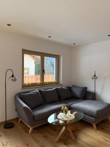 a living room with a couch and a glass table at Apartment Kirchfeld in Aurach bei Kitzbuhel