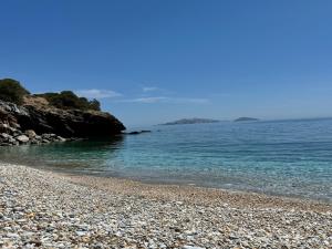 a rocky beach with the ocean in the background at Limnes Seaside Studio in Ligaridia