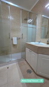 a bathroom with a glass shower and a sink at Maia Surf House - Baleal in Ferrel +47 photos