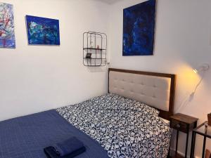 a bedroom with a bed and paintings on the wall at Villa Auguste chambres d'hôtes in Quimper