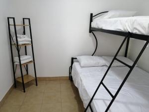 a bedroom with two bunk beds in a room at Casa Debut Surf Place 2 in Parrita
