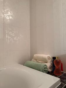 a bathroom with a white tub and towels on the floor at Lily Rose villa in Karlovy Vary +16 photos