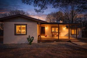 a small house with a porch and a deck at Quiet Escape in Ruidoso