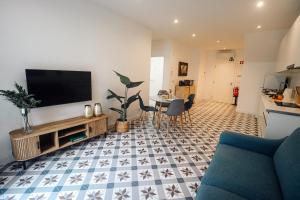 a living room with a flat screen tv on a wall at Peace In Azores in Pico da Pedra