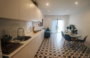 a kitchen with a sink and a table in a room at Peace In Azores in Pico da Pedra