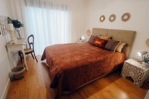 a bedroom with a large bed with a large window at Peace In Azores in Pico da Pedra