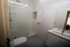 a bathroom with a shower and a toilet and a sink at Peace In Azores in Pico da Pedra +21 photos