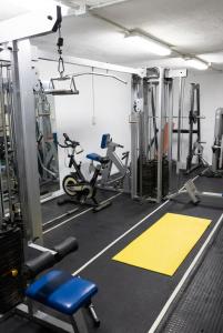 a gym with treadmills and exercise equipment in it at Villa Baena in Granada