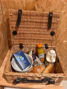 a basket with a plate of food and bread at Bijou Cabin in Ludlow