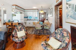a kitchen and living room with chairs and a table at ABSS102 Seaspray 224 in Atlantic Beach