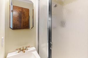 a bathroom with a sink and a mirror at ABSS102 Seaspray 224 in Atlantic Beach +7 photos