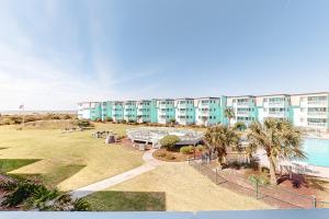 a large apartment building with a pool and palm trees at ABSS102 Seaspray 224 in Atlantic Beach