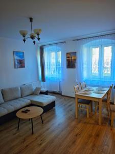 a living room with a couch and a table at Apartament Kris in Wałbrzych
