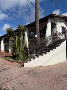 a building with a staircase in front of a house at Hacienda Rosarito in Rosarito Beach