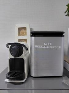 a black and white appliance sitting next to a container at Urban in Suwon