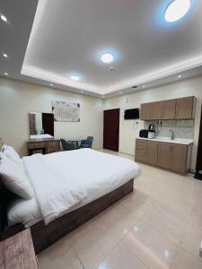 a large bedroom with a large bed and a kitchen at Quba Suites نزل قباء in Medina