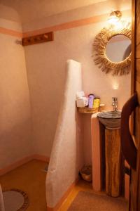 a bathroom with a sink and a mirror at DAR DANI café restaurant in Boumalne Dades