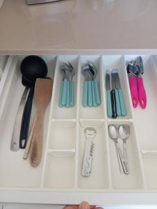 a drawer filled with lots of utensils at Balerna Swiss Apartment by RentuGoo Travel in Balerna
