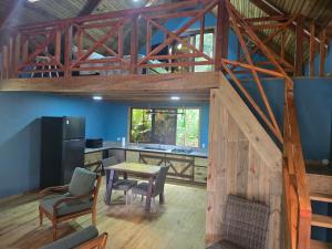 a kitchen and dining room with a table and chairs at The Pause EcoCabin Bocas del Toro in Bocas Town