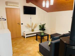 a living room with a couch and a tv at Chiasso Swiss Apartment by RentuGoo Travel in Chiasso