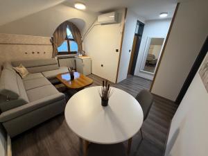a living room with a couch and a table at Guest house Royal in Čakovec