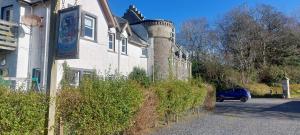 a blue car is parked in front of a house at BZ Green Haven Caravan in Ballantrae