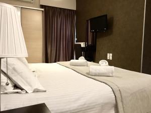 Postel nebo postele na pokoji v ubytování Mc Queen Rooms & Apartments