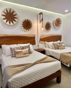 two beds in a room with mirrors on the wall at Bantay 5f in Bucerías +21 photos