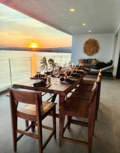 a long wooden table with wine glasses on it at Bantay 5f in Bucerías