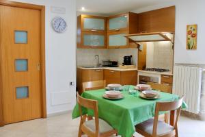 a kitchen with a table with a green table cloth at A Casa Di Giulia - Appartamento sul Lungomare - Giovinazzo in Giovinazzo