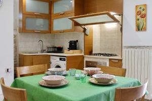 a kitchen with a table with plates and bowls on it at A Casa Di Giulia - Appartamento sul Lungomare - Giovinazzo in Giovinazzo +14 photos