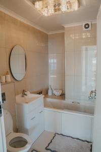 a bathroom with a sink and a toilet and a tub at Seaside tranquility in Gonubie in East London +40 photos