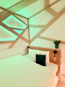 a bedroom with a large white bed with a window at LelleBay in Balatonlelle