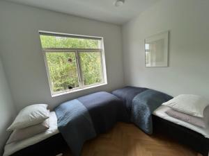 a bedroom with a bed and a window at Seaside apartment in Volda