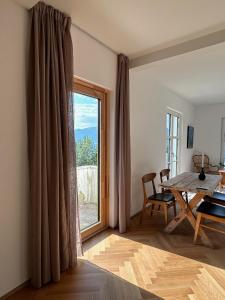 a dining room with a table and a large window at Seaside apartment in Volda