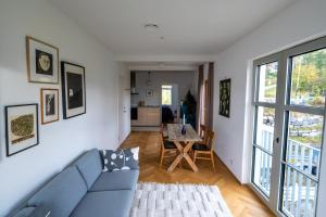 a living room with a blue couch and a table at Seaside apartment in Volda